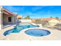 Inviting pool and spa with blue tile in backyard with mountain views at 2540 Youngdale Dr, Las Vegas, NV 89134