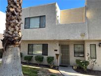 Tan two-story stucco townhouse with mature landscaping and a private entrance at 2679 Jacyra Ave, Las Vegas, NV 89121