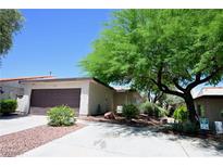 Charming single-story home with a well-manicured front yard, desert landscaping, and an attached two-car garage at 3126 Asoleado Cir, Las Vegas, NV 89121