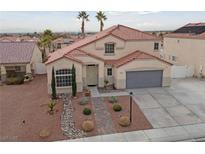 Two-story house with landscaped yard and attached garage at 319 Horse Pointe Ave, North Las Vegas, NV 89084