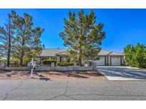 Single-story house with a two-car garage and landscaped yard at 5981 Doubletree Rd, Pahrump, NV 89061