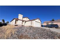 Single-story house with attached garage, situated on a rocky lot at 6166 Evensail Dr, Las Vegas, NV 89156