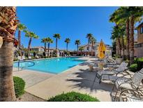 Inviting community pool with lounge chairs and palm trees at 6255 W Arby Ave # 258, Las Vegas, NV 89118