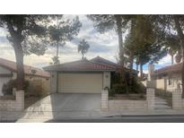 Single-story home with attached garage and landscaped yard at 705 Thousand Oaks Dr, Las Vegas, NV 89123