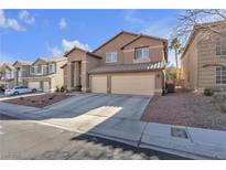 Two-story house with three-car garage and landscaped yard at 8501 Vivid Violet Ave, Las Vegas, NV 89143