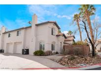 Two-story house with attached garage and landscaped yard at 932 Angel Star Ln, Las Vegas, NV 89145