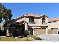 Two-story house with tan exterior, tile roof, and a two-car garage at 9843 Frosty Canyon Ct, Las Vegas, NV 89183