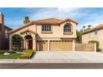 Charming two-story home featuring a well-manicured lawn and a spacious three-car garage at 9843 Frosty Canyon Ct, Las Vegas, NV 89183