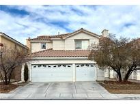 Two-story home showcasing a two-car garage, tile roof, and stucco siding in a residential neighborhood at 9916 Sierra Canyon Way, Las Vegas, NV 89147