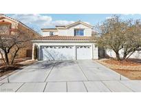 Two-story home featuring a concrete driveway and an attached two-car garage at 9916 Sierra Canyon Way, Las Vegas, NV 89147