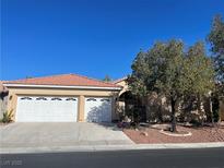 Single-story house with three-car garage and desert landscaping at , Las Vegas, NV 89123