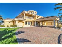 Stunning home features a circular driveway, porte cochere, lush landscaping, and grand architectural design at 1245 S Rancho Dr, Las Vegas, NV 89102