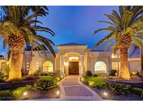 Elegant home with palm trees, landscaped yard, and a grand entrance at 2200 Nordica Ct, Las Vegas, NV 89117