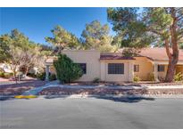 Tan stucco house with tile roof, walkway, and landscaping at 2851 S Valley View Blvd # 1172, Las Vegas, NV 89102