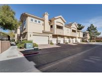 Tan two-story building with attached garages and landscaping at 3555 Meridale Dr # 1145, Las Vegas, NV 89147