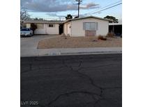 Ranch style home with a large yard and driveway at 6256 Dayton Ave, Las Vegas, NV 89107