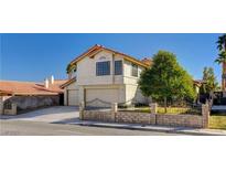 Two-story house with a two-car garage and a landscaped front yard at 7445 Shangri La Ave, Las Vegas, NV 89147