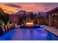 Stunning backyard oasis with a pool, fire pit, and water feature at 11885 Grassy Plain Ave, Las Vegas, NV 89138