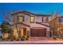 Charming two-story home with a covered porch, two-car garage and landscaped front yard at 12259 Pacific Cruise Ave, Las Vegas, NV 89138