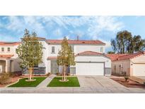 Two-story house with a white exterior, two-car garage, and landscaped front yard at 3728 Shimmering Creek Ave, North Las Vegas, NV 89031