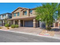 Two-story house with gray siding, stone accents, and a two-car garage at 4128 Fossatello Ave, North Las Vegas, NV 89084