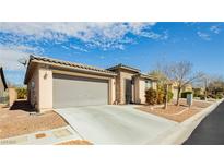 Charming single-story home featuring a two-car garage, desert landscaping, and a welcoming facade at 5468 Carrara Pointe St, Pahrump, NV 89061