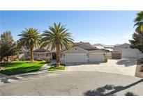 Charming single-story home with mature palm trees, three-car garage, and well-maintained landscaping at 5625 W Agate Ave, Las Vegas, NV 89139