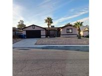 Single story home with a two car garage and xeriscaped yard at 6741 Solaron Ave, Las Vegas, NV 89156