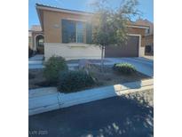 One-story house with desert landscaping, attached garage, and neutral color scheme at 825 Great Sky Ct, North Las Vegas, NV 89084