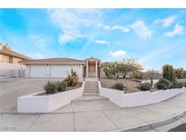 Charming single-story home with stucco exterior, tile roof, and well-manicured desert landscaping at 1044 Geranium Dr, Henderson, NV 89011