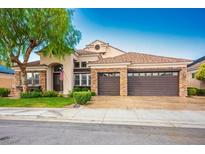 Charming single-Gathering home showcasing a meticulously maintained lawn and a spacious three-car garage at 2012 Poetry Ave, Henderson, NV 89052