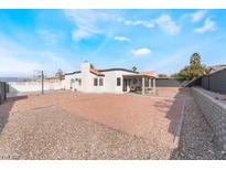 Spacious backyard with gravel, covered patio, and basketball court at 2258 Ray Kanel Dr, Las Vegas, NV 89156