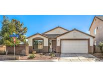 Charming single-story home featuring a well-maintained front yard, two-car garage, and neutral-colored exterior at 2301 Bahama Point Ave, North Las Vegas, NV 89031