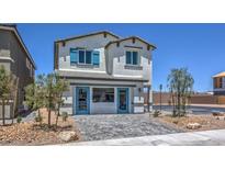 Two-story home with teal accents and a paved driveway at 2634 Snapdragon Falls Ave # 95, North Las Vegas, NV 89081