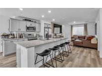 Bright kitchen features a large island with seating, granite countertops and stainless steel appliances at 2827 Blue Mosaic Ln # 3, Las Vegas, NV 89183