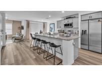 Modern kitchen boasts stainless steel appliances, granite countertops, and a breakfast bar with seating at 2827 Blue Mosaic Ln # 3, Las Vegas, NV 89183