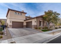 Two-story house with stone and stucco exterior, brown garage doors, and landscaped yard at 37 Carolina Cherry Dr, Las Vegas, NV 89141