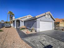 Charming single-story home with a tile roof, two-car garage, and low-maintenance desert landscaping at 4004 Adelphi Ave, Las Vegas, NV 89120