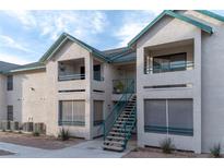 Two-story building exterior with teal accents and stairs at 5261 Lindell Rd # 205, Las Vegas, NV 89118
