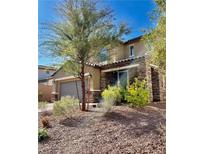 Beautiful two-story home with well-maintained landscaping, desert rocks, and a charming facade at 625 Loyalty Ct, Henderson, NV 89011