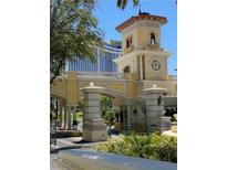 Elegant community entrance with a clock tower and manicured landscaping at 2777 Paradise Rd # 1105, Las Vegas, NV 89109