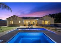 Relaxing backyard oasis featuring a refreshing pool, lounge chairs, and inviting patio furniture at 4292 Helena Cove Ct, Las Vegas, NV 89129