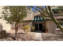 Inviting exterior of a two-story stucco home with a landscaped front yard and walkway at 6750 Del Rey Ave # 102, Las Vegas, NV 89146