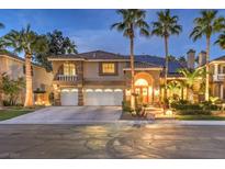 Two-story house with a three-car garage, palm trees, and well-manicured landscaping at 1240 Fragrant Spruce Ave, Las Vegas, NV 89123
