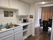 Bright eat-in kitchen with white cabinets and modern appliances at 200 N Bruce St # A, Las Vegas, NV 89101
