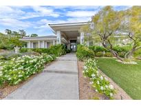 Beautiful two-story home with landscaped entry and walkway at 2049 Troon Dr, Henderson, NV 89074