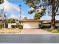 Charming single-story home features a well-maintained front yard and a two-car garage with a brick driveway at 3416 Calle De Corrida, Las Vegas, NV 89102