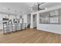 Modern kitchen with island, stainless steel appliances, and white cabinetry at 3596 April Springs St, Las Vegas, NV 89147