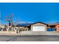 Tan house with solar panels, white garage door, and a small front yard at 3910 Geist Ave, Las Vegas, NV 89115