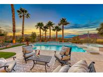 Luxury pool with patio furniture, offering stunning sunset views at 61 Contrada Fiore Dr, Henderson, NV 89011